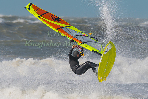 A windsurfer leaps clear of the waves at Rhosneigr Beach in Ange