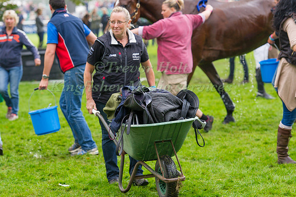 Jackie Potts head girl to William Fox-Pitt heads back to the stable with a wheel barrow full of Tack