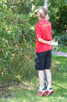 Chris Bartle peeks through the trees to watch the trot up