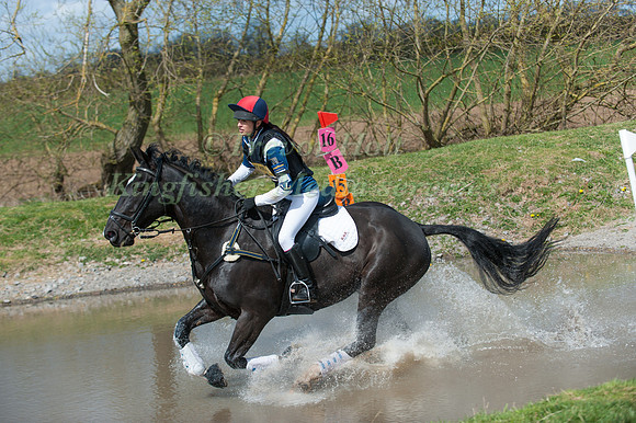 Horse and rider running through water
