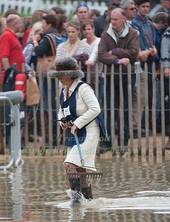 Well Dressed Fence Judge wading with rake