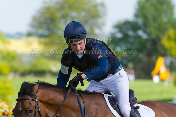 Tom How checking his watch approaching the finishing line