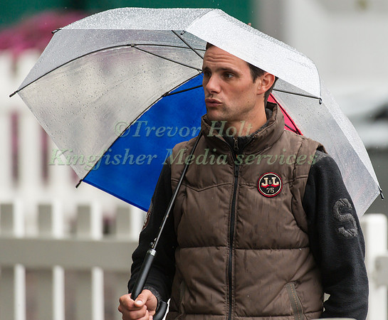 Nicolas Touzaint shetering from the rain