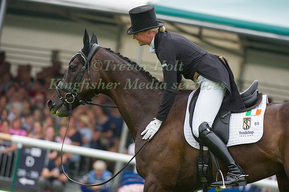 Aoife Clark (IRL) riding Vaguely North patting horse at the end of her test