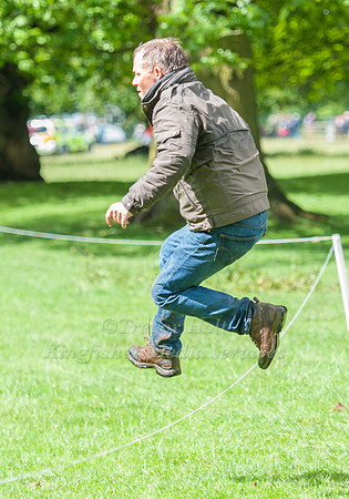 Hinrich Romeike taking a jump on course whilst watching his son complete
