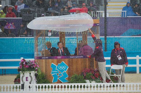 Ground Staff hold down the rain screen on the judges box during Kristina Cook's Test